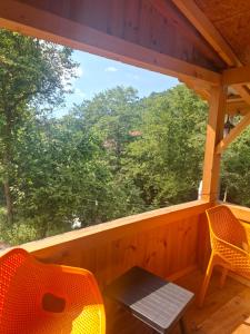 a screened in porch with a table and two chairs at Altın Vadi Konaklama in Fındıklı +6 photos