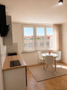 a kitchen with a table and chairs in a room at Apartament 3 Maja in Brodnica