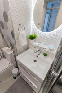 a bathroom with a white sink and a mirror at Apartman Nika-Self check-in,Free Parking in Vukovar +18 photos