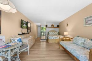 a living room with a couch and a bed at Kona Islander Inn#228: Located in downtown Kona! in Kailua-Kona