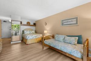 a bedroom with two beds and a mirror at Kona Islander Inn#228: Located in downtown Kona! in Kailua-Kona +37 photos