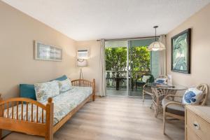 a living room with a couch and a table at Kona Islander Inn#228: Located in downtown Kona! in Kailua-Kona