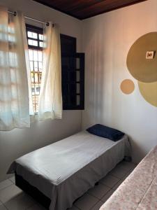 a bedroom with a bed and a window at Espaço Cultural Morada in São Luís