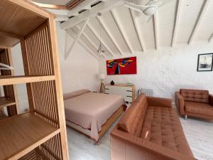 a small bedroom with a bed and a couch at Casa Cueva Tejeda 2 dorm in Tejeda