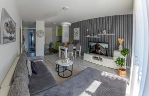 a living room with a couch and a tv at Apartman Nika-Self check-in,Free Parking in Vukovar