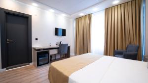 a hotel room with a bed and a desk at Kıyı Hotel Restaurant in Gebze