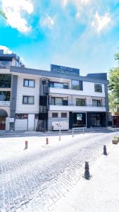 a large white building with a sign on it at Kıyı Hotel Restaurant in Gebze