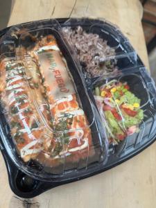 a plastic container filled with food on a table at Hotel Azulado - Como el mar in Jamundí