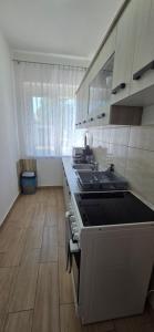 a kitchen with a stove and a sink in it at Mária 93 in Balatonmáriafürdő