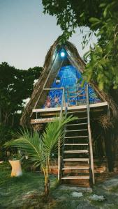 a tree house with a staircase leading to it at Cabana Jamelão in Camaçari