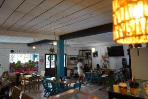 a restaurant with tables and chairs and a man standing in a room at Tortugas Brews B&B in Bocas Town