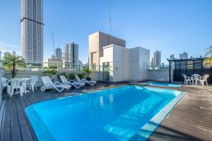 a swimming pool on the roof of a building at Hotel Rosenbrock in Balneário Camboriú