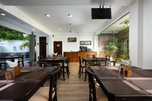 a restaurant with tables and chairs in a room at Luminara Sky Lounge with Pool near Ahangama Beach in Ahangama