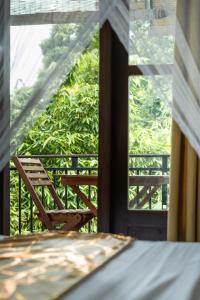 a room with a table and a chair in front of a window at Luminara Sky Lounge with Pool near Ahangama Beach in Ahangama +44 photos