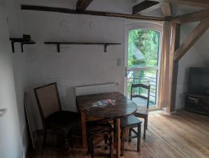 a dining room with a table and chairs and a window at Zum altem Forsthof Grittel in Grittel
