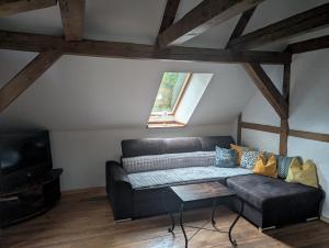 a living room with a couch and a tv at Zum altem Forsthof Grittel in Grittel