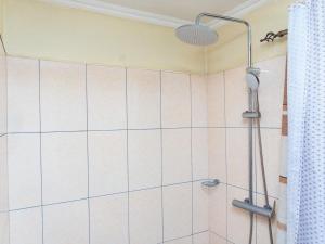 a shower with a shower head in a bathroom at JAC Tilama BNB in Blantyre