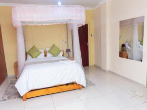 a bedroom with a bed with a canopy at JAC Tilama BNB in Blantyre
