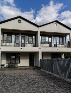 a large white building with windows and a fence at Spitak tun in Ijevan