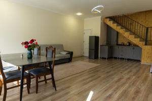 a living room with a dining table and a kitchen at Spitak tun in Ijevan