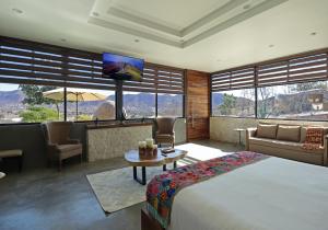 a hotel room with a bed and a large window at Parra del Valle Hotel Boutique in Valle de Guadalupe +60 photos