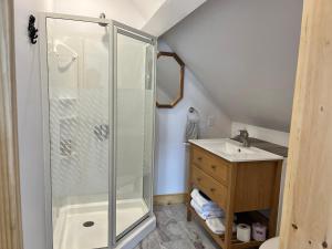 a bathroom with a shower and a sink at Seaside Beach Resort in Saint Andrews +51 photos