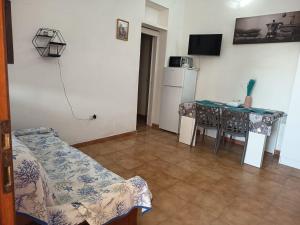 a living room with a table and a dining room at Tropea's green terrace in Tropea