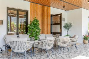a group of chairs and a table on a patio at Penzion Šterk in Most na Soči