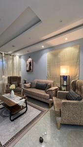 a large living room with couches and a table at شقة ريفالا الفاخرة in Abha
