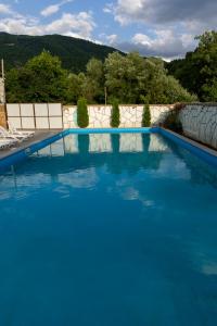 a large swimming pool with blue water in a yard at Spitak tun in Ijevan
