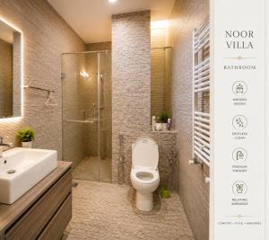a bathroom with a toilet and a sink and a shower at Luxury Noor Villa in Khaira Gali +9 photos
