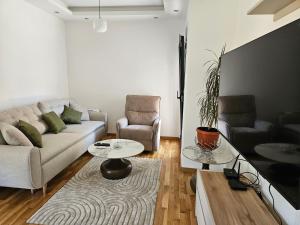 a living room with a couch and a table at Apartman Kiki in Šušanj