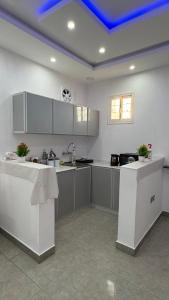 a kitchen with white counters and a blue ceiling at شقة ريفالا الفاخرة in Abha +16 photos