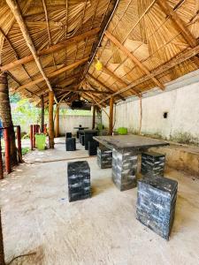 a large room with a large table and chairs at G Lake Guest House in Mahiyangana