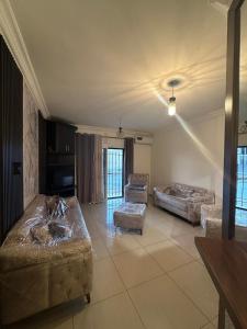 a living room with two couches and a couch at Berbara, Chadi in Dayr Jannīn