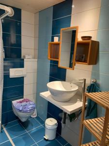 a bathroom with a sink and a toilet at Nuwach in Sauges