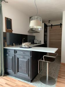 a kitchen with a white counter and a chair at Nuwach in Sauges