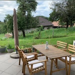 a wooden table and chairs on a patio at Nuwach in Sauges