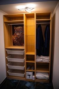 a walk in closet with wooden cabinets and shelves at Ó maestro home in Avignon