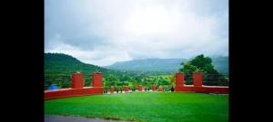 a large park with a view of the mountains at LODHA VINTAGE Atdc in Kolvan