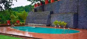a swimming pool in the middle of a yard at LODHA VINTAGE Atdc in Kolvan