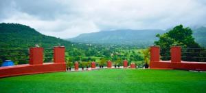 a view of a green field with mountains in the background at LODHA VINTAGE Atdc in Kolvan
