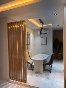 a dining room with a table and chairs and a ceiling at Jasabi Apartments in Port Harcourt