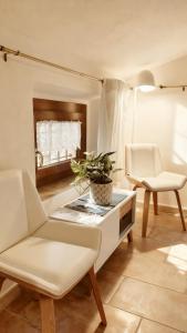a living room with two chairs and a table at Casa Due Marie Boutique stay near Modena & Maranello in Marano sul Panaro