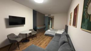 a living room with a couch and a bed at Go Bamboo Beach Apartments in Ts'ikhisdziri +21 photos