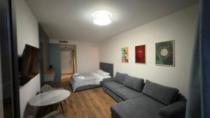 a living room with a couch and a bed at Go Bamboo Beach Apartments in Ts'ikhisdziri