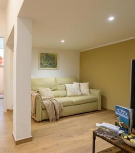 a living room with a couch and a table at Villa del Mare Virgo Home in Nettuno