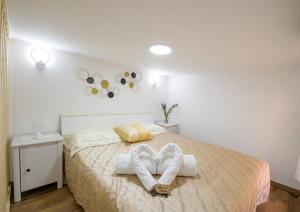 a bedroom with a bed with towels on it at Villa del Mare Virgo Home in Nettuno +31 photos