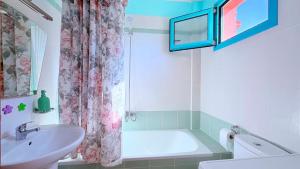 a bathroom with a tub and a sink and a shower at Aurora Maris Maisonette in Possidi +13 photos