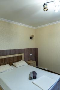 a bedroom with two white beds in a room at Spitak tun in Ijevan